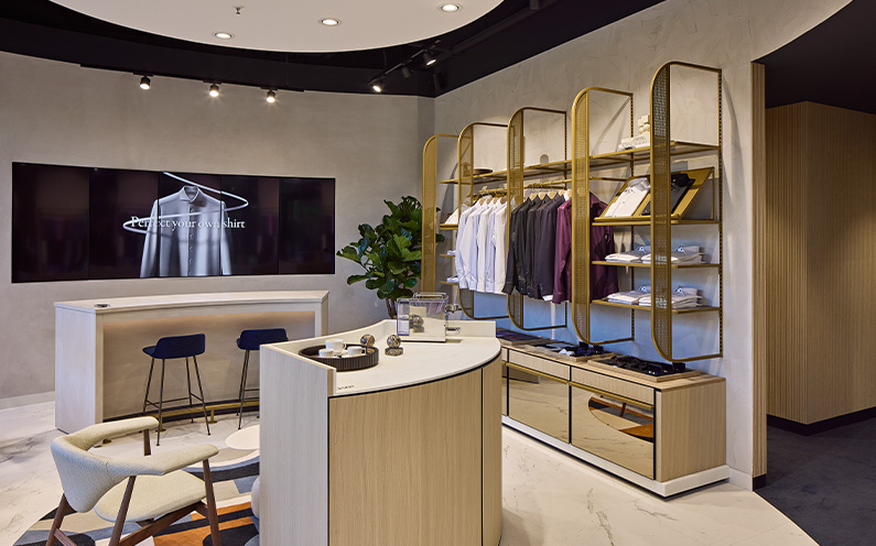 Eton store interior with large digital screen for brand communication.